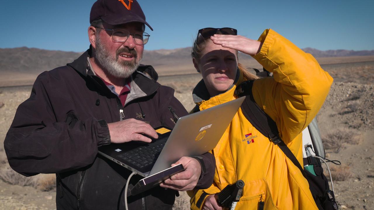 Michael Tuite and Rachel Kronyak of NASA's Jet Propulsion Laboratory in a dry lakebed in the Nevada desert. During the February 2020 exercise, they served as part of a field team that stood in as Mars a rover, receiving commands to seek out images and other data for review by scientists who will work with NASA's Perseverance Mars rover. https://photojournal.jpl.nasa.gov/catalog/PIA23892