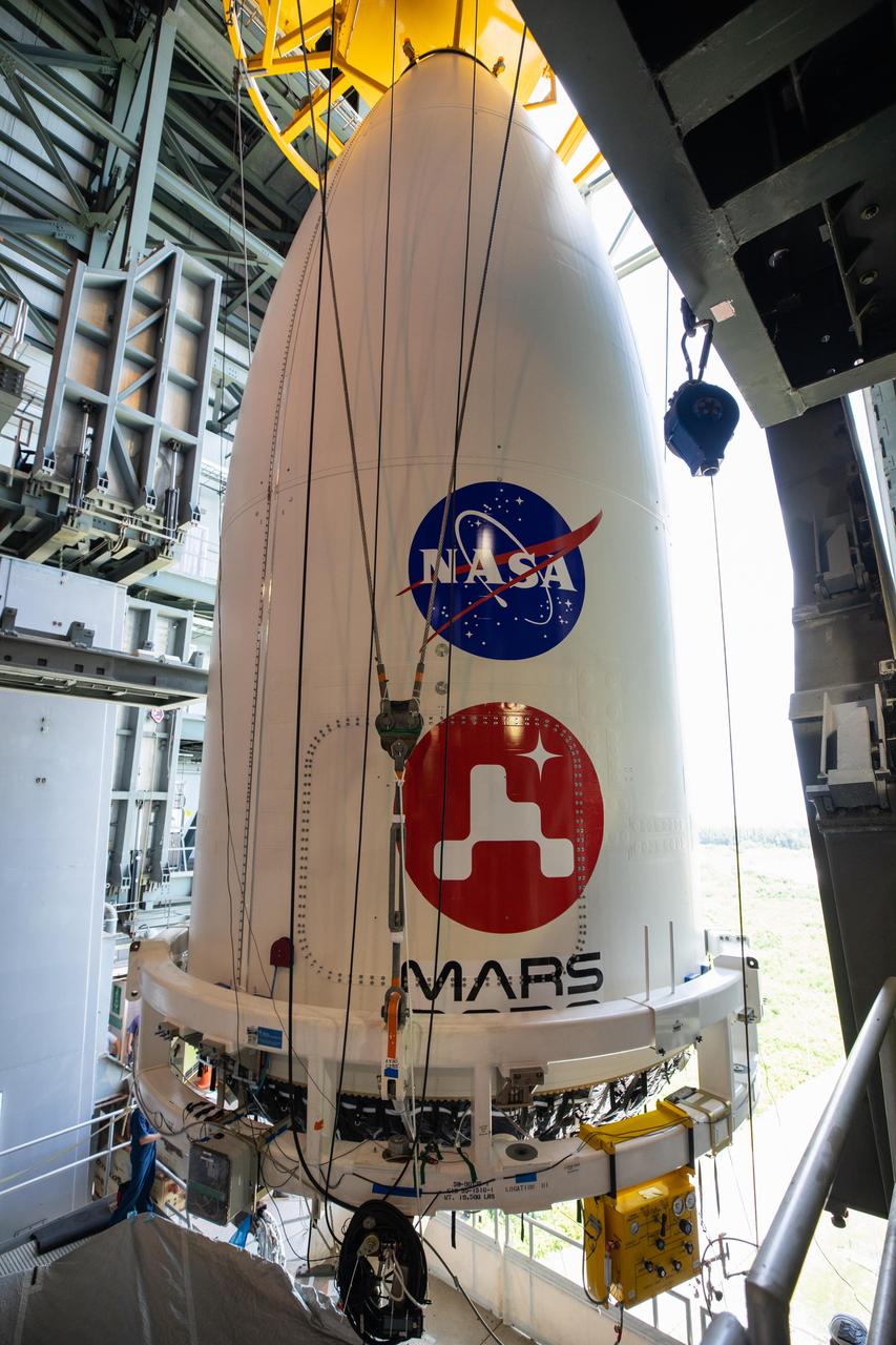 The payload fairing, or nose cone, containing NASA's Mars 2020 Perseverance rover is maneuvered into place atop the Atlas V rocket that will hurl it toward Mars. The image was taken on July 7, 2020, inside the Vertical Integration Facility at Cape Canaveral Air Force Station's Space Launch Complex 41 in Florida. https://photojournal.jpl.nasa.gov/catalog/PIA23986