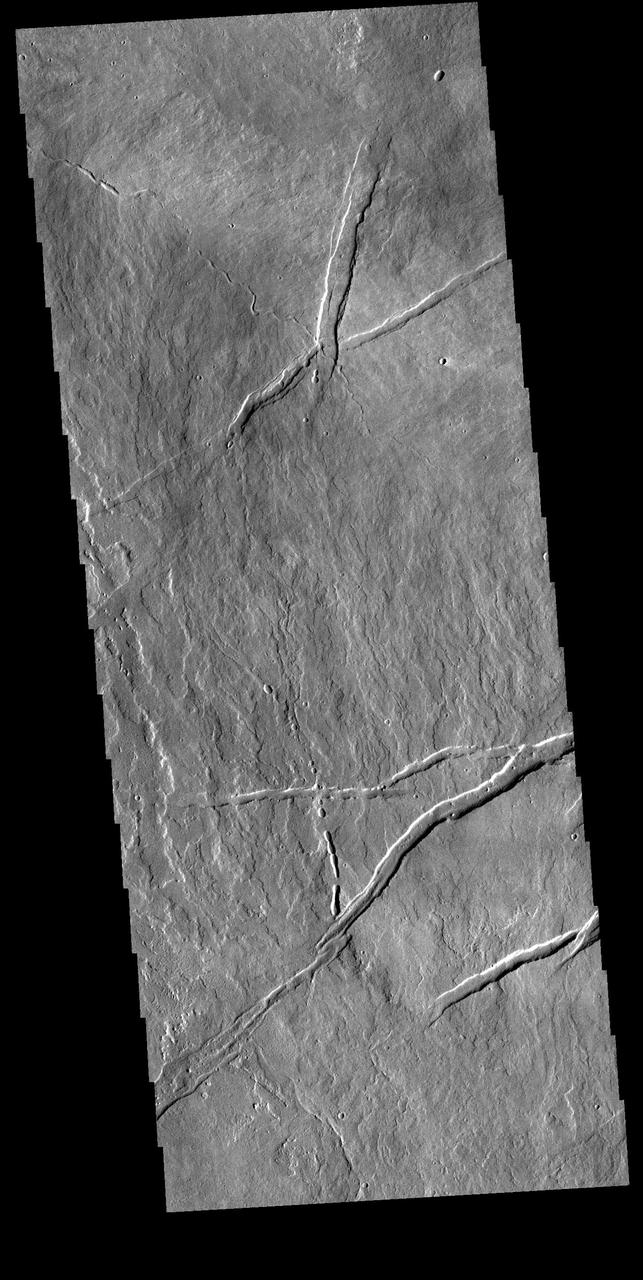 Today's VIS image is located just east of Arsia Mons. Numerous volcanic flows are visible, flowing downhill to the lower right side of the image. Several tectonic graben are present, generally trending perpendicular to the flows. A small channel feature and a discontinuous channel follow the flow trend. These features are likely lava channels and lava tube traces. Orbit Number: 81763 Latitude: -7.28995 Longitude: 244.476 Instrument: VIS Captured: 2020-05-20 16:20 https://photojournal.jpl.nasa.gov/catalog/PIA24012