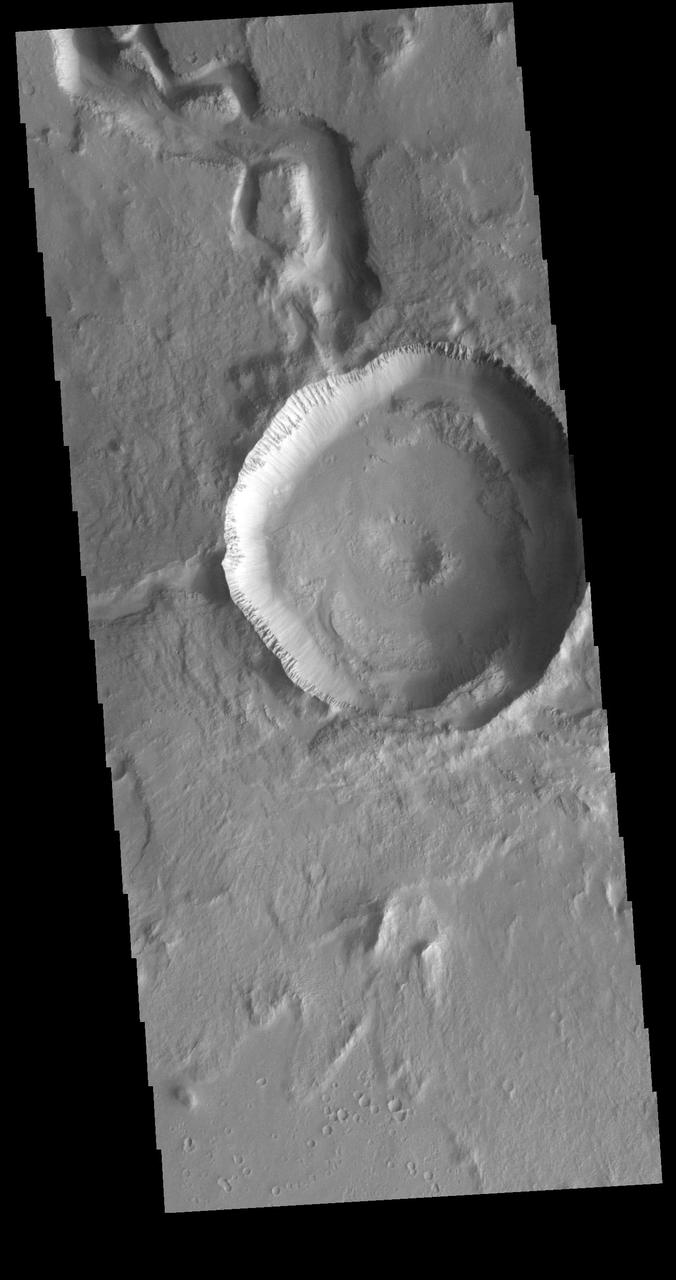 This VIS image is located in Utopia Planitia and shows part of Hephaestus Fossae. Hephaestus Fossae is a complex channel system. It has been proposed that the channel formed by the release of melted subsurface ice during the impact event that created a large crater in the center of this image. Additionally, the nearby Elysium volcanic center created subsurface heating that may have played a part in creating both Hephaestus Fossae and Hebrus Valles to the north. Orbit Number: 81767 Latitude: 17.6969 Longitude: 125.709 Instrument: VIS Captured: 2020-05-21 00:22 https://photojournal.jpl.nasa.gov/catalog/PIA24014