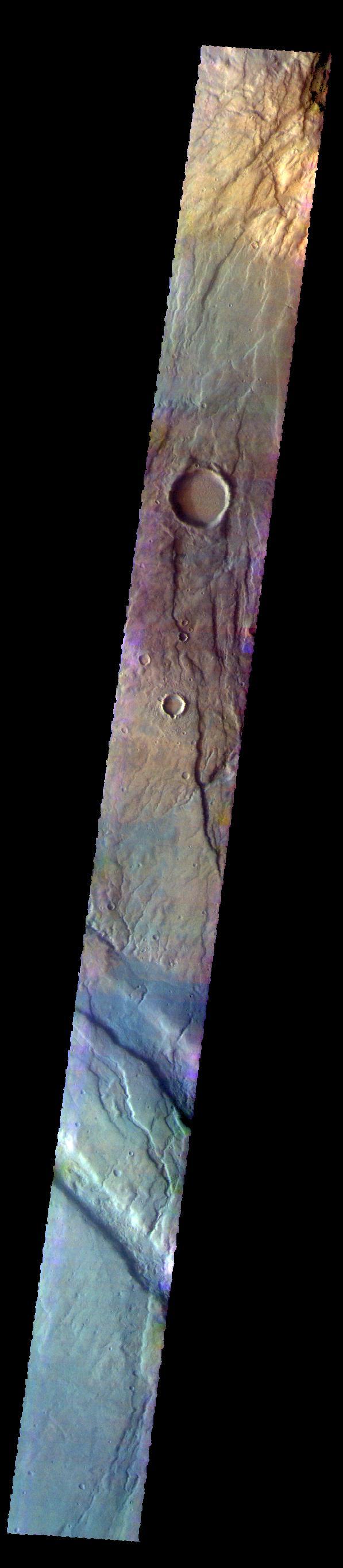 The THEMIS VIS camera contains 5 filters. The data from different filters can be combined in multiple ways to create a false color image. These false color images may reveal subtle variations of the surface not easily identified in a single band image. Today's false color image shows part of Claritas Fossae. The graben filled highlands are bounded by Solis Planum to the northeast and Icaria Planum to the southwest. The linear features (fossae) are graben, a tectonic feature created when blocks of material subside between paired faults. Extensional tectonic forces are responsible for graben formation. While close to the Tharsis region, it is thought that Claritas Fossae formed prior to the large lava flows located north of this image.  Orbit Number: 67635 Latitude: -41.3176 Longitude: 260.749 Instrument: VIS Captured: 2017-03-13 23:52  https://photojournal.jpl.nasa.gov/catalog/PIA24074