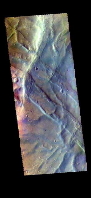 The THEMIS VIS camera contains 5 filters. The data from different filters can be combined in multiple ways to create a false color image. These false color images may reveal subtle variations of the surface not easily identified in a single band image. Today's false color image shows part of Claritas Fossae. The linear features in the image are graben, formed when a block of material subsides between paired faults in a region of extensional tectonic stress. Orbit Number: 67778 Latitude: -39.8482 Longitude: 269.945 Instrument: VIS Captured: 2017-03-25 19:11 https://photojournal.jpl.nasa.gov/catalog/PIA24076