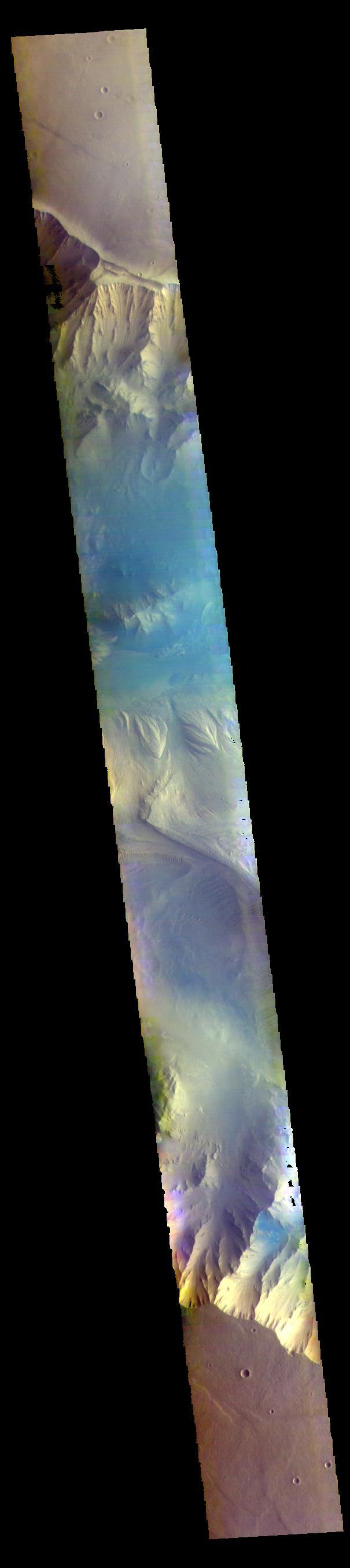 The THEMIS VIS camera contains 5 filters. The data from different filters can be combined in multiple ways to create a false color image. These false color images may reveal subtle variations of the surface not easily identified in a single band image. Today's false color image shows part of eastern Candor Chasma. Candor Chasma is one of the largest canyons that make up Valles Marineris. It is approximately 810 km long (503 miles) and has is divided into two regions — eastern and western Candor. Candor is located south of Ophir Chasma and north of Melas Chasma. The border with Melas Chasma contains many large landslide deposits. The floor of Candor Chasma includes a variety of landforms, including layered deposits, dunes, landslide deposits and steep sided cliffs and mesas. Many forms of erosion have shaped Candor Chasma. There is evidence of wind and water erosion, as well as significant gravity driven mass wasting (landslides).  Orbit Number: 68438 Latitude: -7.05392 Longitude: 291.853 Instrument: VIS Captured: 2017-05-19 04:30  https://photojournal.jpl.nasa.gov/catalog/PIA24078