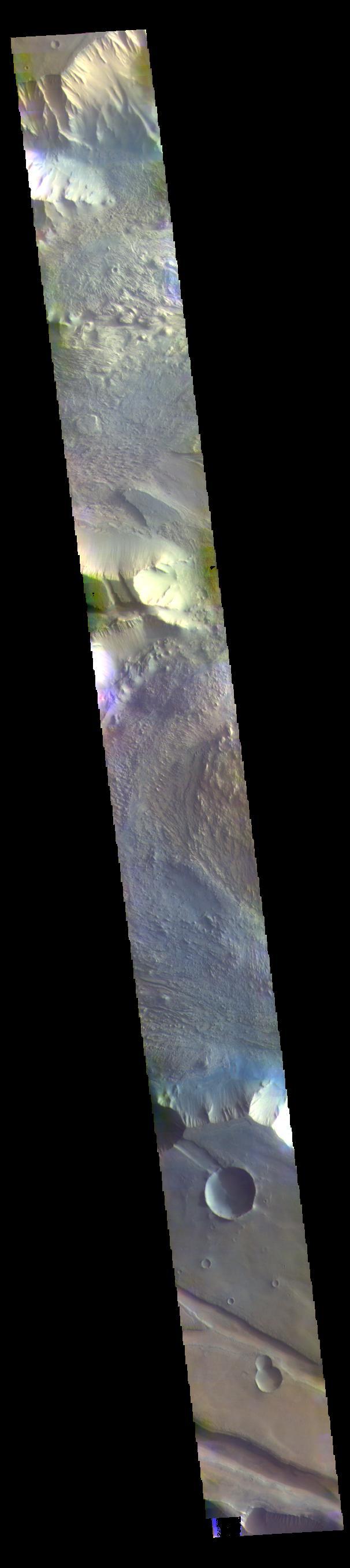 The THEMIS VIS camera contains 5 filters. The data from different filters can be combined in multiple ways to create a false color image. These false color images may reveal subtle variations of the surface not easily identified in a single band image. Today's false color image shows part of western Candor Chasma. Candor Chasma is one of the largest canyons that make up Valles Marineris. It is approximately 810 km long (503 miles) and has is divided into two regions — eastern and western Candor. Candor is located south of Ophir Chasma and north of Melas Chasma. The border with Melas Chasma contains many large landslide deposits. The floor of Candor Chasma includes a variety of landforms, including layered deposits, dunes, landslide deposits and steep sided cliffs and mesas. Many forms of erosion have shaped Candor Chasma. There is evidence of wind and water erosion, as well as significant gravity driven mass wasting (landslides).  Orbit Number: 69411 Latitude: -5.95186 Longitude: 283.147 Instrument: VIS Captured: 2017-08-07 08:33  https://photojournal.jpl.nasa.gov/catalog/PIA24081