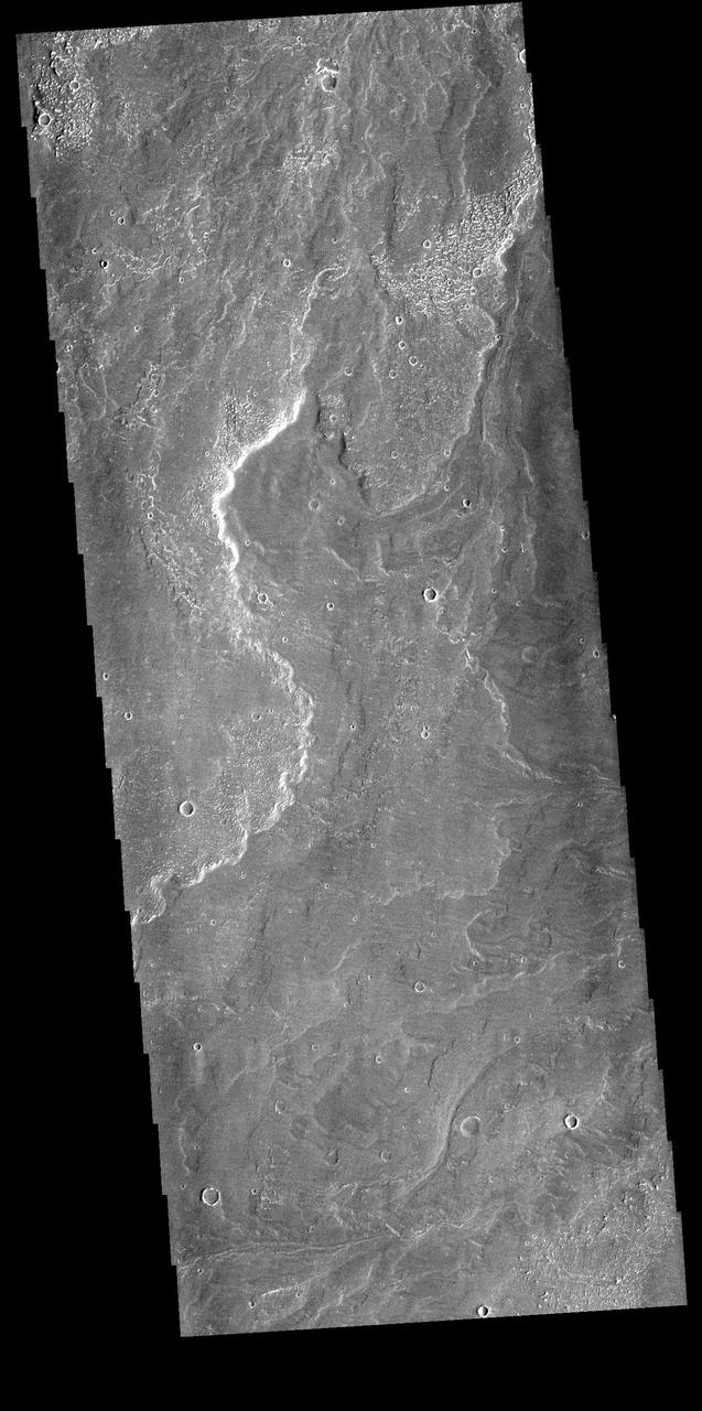 Today's VIS image shows a small part of Daedalia Planum. The lava flows originate from Arsia Mons, one of the large volcanoes in the Tharsis region. The different surface textures are created by differences in the lava viscosity and cooling rates. The lobate margins of each flow can be traced back to the start of each flow — or to the point where they are covered by younger flows. Flows in Daedalia Planum can be as long as 180 km. Orbit Number: 81888 Latitude: -22.8438 Longitude: 240.412 Instrument: VIS Captured: 2020-05-30 23:16 https://photojournal.jpl.nasa.gov/catalog/PIA24086