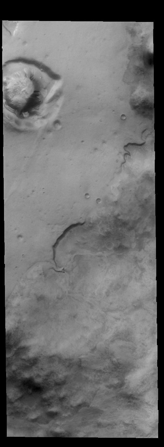 Today's VIS image is located in southern Noachis Terra. There is a crater-like form in the upper left of this image, with an interior mound that appears to be even with the rim of the circular depression. It is not understood how such mounds are created. The side of the mound contains several gullies.  Orbit Number: 82271 Latitude: -69.2758 Longitude: 1.34513 Instrument: VIS Captured: 2020-07-01 11:53  https://photojournal.jpl.nasa.gov/catalog/PIA24144
