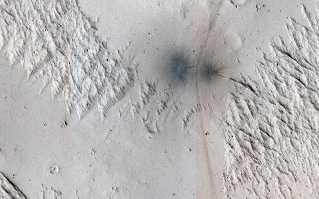 NASA image: A Criss-Cross Landscape with Fresh Craters
