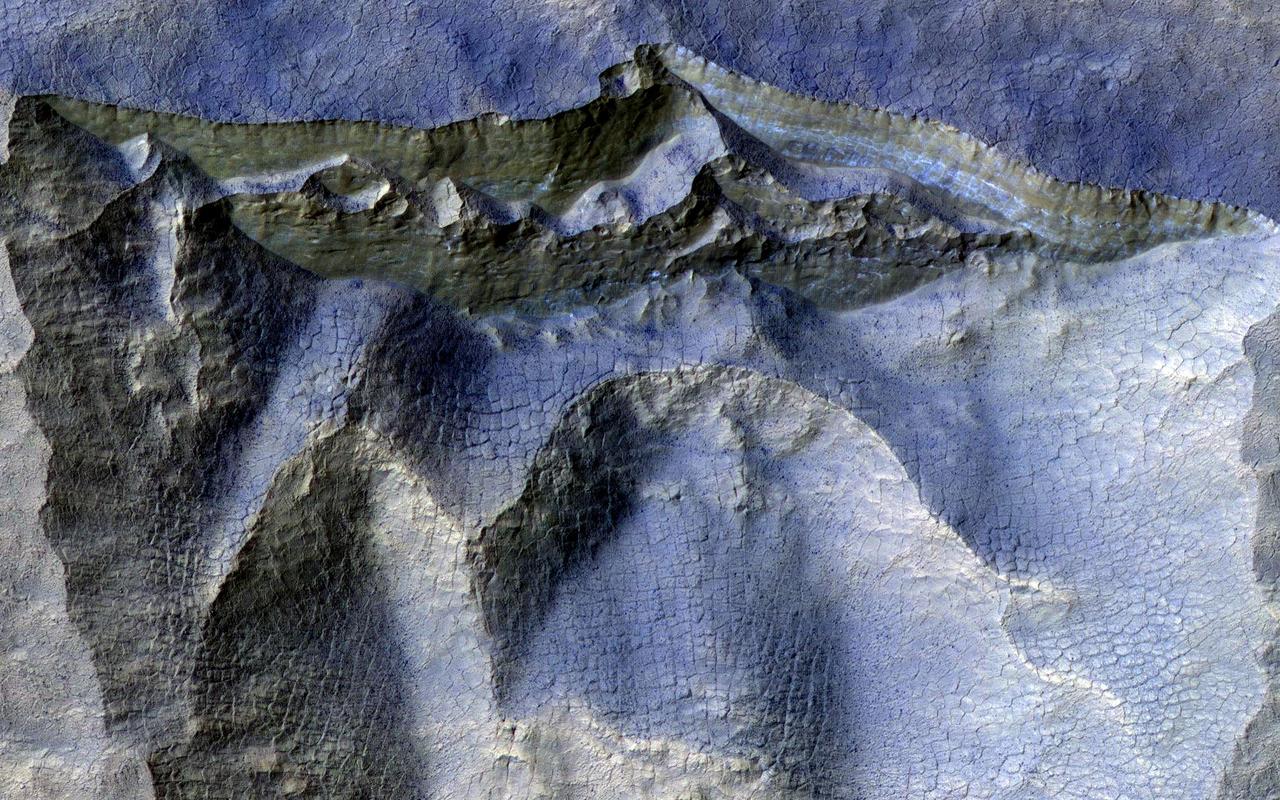 Scientists have come to realize that, just below the surface, about one third of Mars is covered in ice. We study this ice to learn about Mars' ancient climate and astronauts' future water supplies.  Sometimes we see the buried ice because cliffs form like the one in this image. On the brownish, dusty cliff wall, the faint light-blue-colored ice shows through. Some of these cliffs change before our eyes and boulders of ice can tumble downhill. We take repeat images of these scenes to check for changes like this.  https://photojournal.jpl.nasa.gov/catalog/PIA24147
