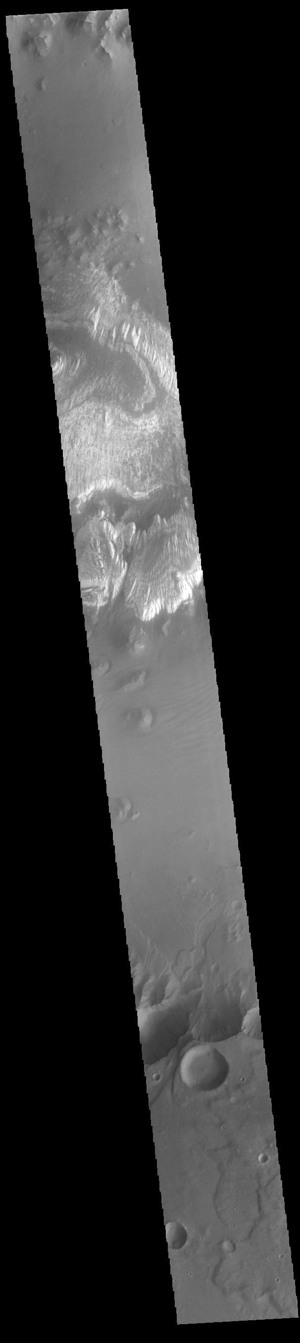 This VIS image shows part of the floor of Ganges Chasma. Deposits of fine surface materials and bright layered deposits are visible in this image. Ganges Chasma is part of the Valles Marineris chasma system, but is north of the main section of canyons.  Orbit Number: 82734 Latitude: -7.8794 Longitude: 311.753 Instrument: VIS Captured: 2020-08-08 15:10  https://photojournal.jpl.nasa.gov/catalog/PIA24156