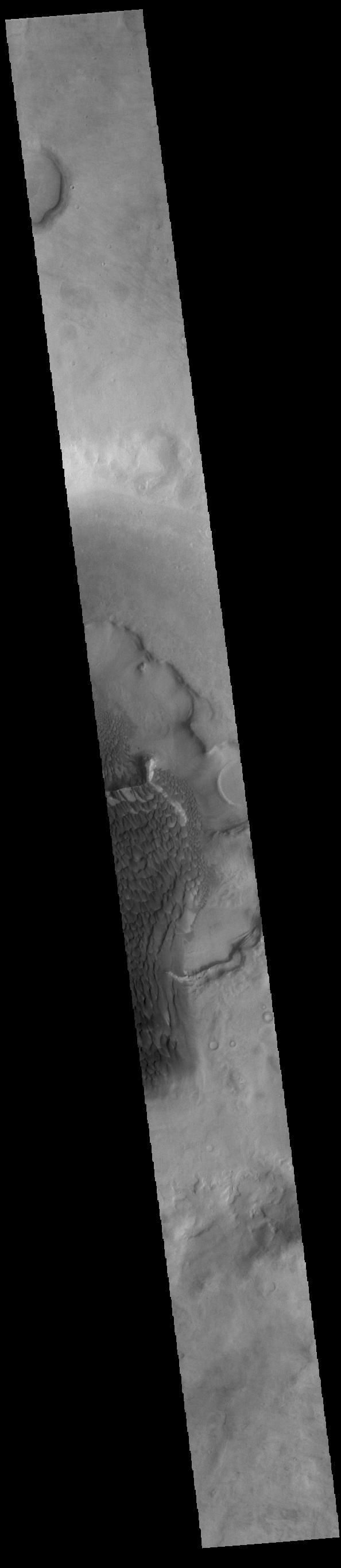 The dunes seen in this VIS image are located on the complex floor of Rabe Crater. The sand is likely derived by erosion into the deposit that fills most of the crater floor, creating a pit which hosts the dunes. Rabe Crater is located in Noachis Terra and is 108km in diameter (67 miles).  Orbit Number: 82906 Latitude: -43.447 Longitude: 35.0145 Instrument: VIS Captured: 2020-08-22 18:52  https://photojournal.jpl.nasa.gov/catalog/PIA24184