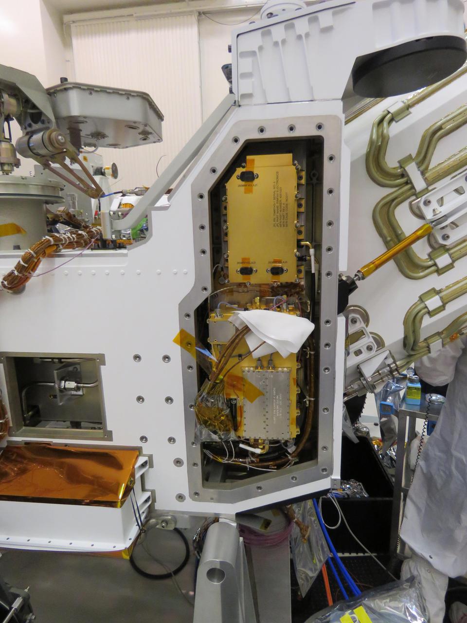 This image, taken in the clean room at NASA's Jet Propulsion Laboratory in Southern California, shows the Radar Imager for Mars' Subsurface Experiment (RIMFAX) electronic's box after it has been inserted into the Perseverance rover. The gold-plated electronics box is at the top of the opening. RIMFAX's antenna will be mounted on the bottom rear of the rover. https://photojournal.jpl.nasa.gov/catalog/PIA24204