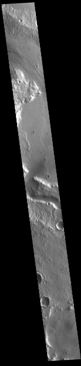 The wide channel in the center of this VIS image is Tinto Vallis. This northward flowing channel is 180 km (112 miles) long and is located in northern Hesperia Planum. Tinto Vallis arises in the plains of Herperia Planum and empties into Palos Crater. In this image Tinto Vallis doglegs to the north, entering Palos Crater, and then exiting again into the northern lowland of Amenthes Planum. Orbit Number: 85973 Latitude: -3.08676 Longitude: 110.715 Instrument: VIS Captured: 2021-05-02 07:46 https://photojournal.jpl.nasa.gov/catalog/PIA24216