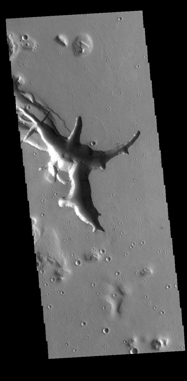 Located west of the Elysium Volcanic complex, Hebrus Valles is a channel system that flowed to the north. This VIS image shows the complex region at the start of the channel. The process that formed the channel system is unknown. Some of the channel features have the appearance of being formed by liquid flow. In other portions of the valles, there are pits and collapse features which appear to have formed by material falling into subsurface voids. This is a common feature in regions of volcanic activity where lava tubes run below the surface. Both water and lava probably contributed to the formation of Hebrus Valles. Hebrus Valles is located in southern Utopia Planitia and is 325km (202 miles) long. Orbit Number: 86147 Latitude: 17.8139 Longitude: 128.204 Instrument: VIS Captured: 2021-05-16 15:44 https://photojournal.jpl.nasa.gov/catalog/PIA24225