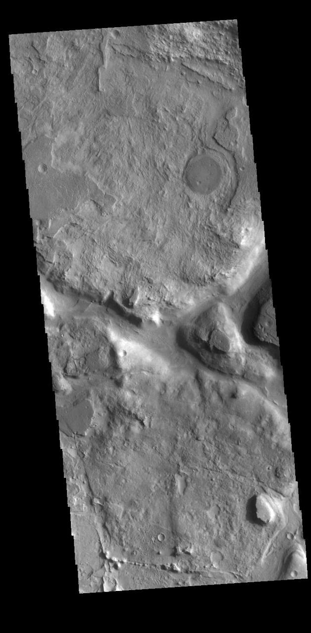 Today's VIS image shows part of a heavily eroded crater near the northern margin of Terra Sabaea. This region is heavily eroded and dissected by a multitude of unnamed channels, regions of chaos and old craters. This crater has a channel within it, seen on the right side of this image. Orbit Number: 86149 Latitude: 31.175 Longitude: 68.5579 Instrument: VIS Captured: 2021-05-16 19:45 https://photojournal.jpl.nasa.gov/catalog/PIA24226