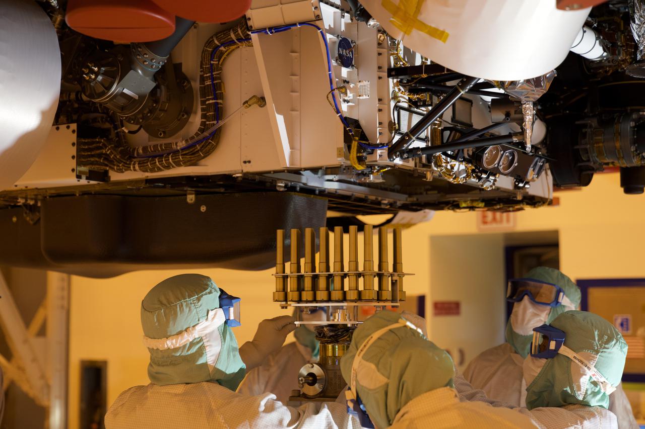A tray holding 39 sample tubes headed to Mars is installed into the Perseverance rover on May 21, 2020, in a clean room at NASA's Kennedy Space Center in Florida during final installation for launch. Each tube is enveloped in its own gold-colored titanium sheath that protects it until the sample handling arm within the rover retrieves it to begin the process of collecting a sample of Martian rock or regolith (dust and crushed rock). In total, the rover carries 43 sample tubes.  https://photojournal.jpl.nasa.gov/catalog/PIA24305