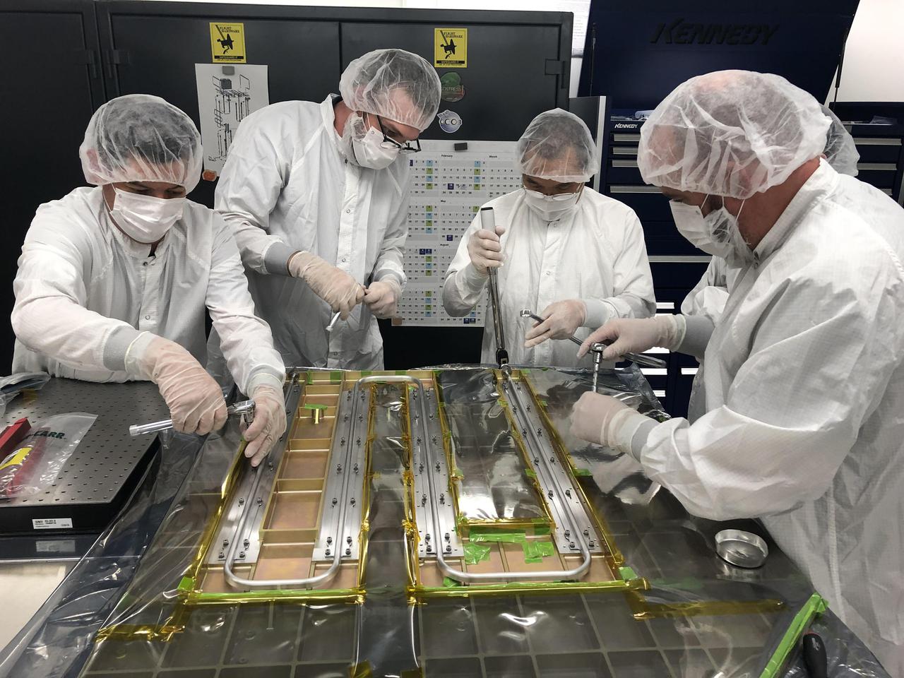 Europa Clipper technicians and engineers at NASA's Jet Propulsion Laboratory in Southern California work together in a cleanroom on Sept. 12, 2019. They bond thermal tubing to the spacecraft's Radio Frequency (RF) panel, which was built by Johns Hopkins University Applied Physics Laboratory (APL) in Laurel, Maryland. The tubing is part of a Heat Redistribution System (HRS) that pumps coolant all around the spacecraft and helps control its temperature as it travels through space.  With an internal global ocean twice the size of Earth's oceans combined, Europa may have the potential to harbor life. NASA's Europa Clipper spacecraft will swoop around Jupiter on an elliptical path, dipping close to the moon on each flyby to collect data. Understanding Europa's habitability will help scientists better understand how life developed on Earth and the potential for finding life beyond our planet. Europa Clipper is aiming for a launch readiness date of 2024.  https://photojournal.jpl.nasa.gov/catalog/PIA24324