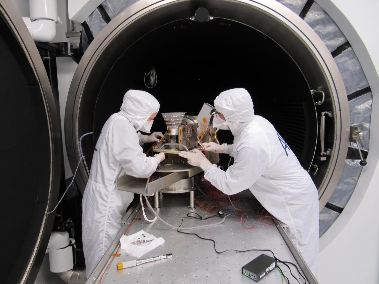 Included in the payload of science instruments for NASA's Europa Clipper is the Europa Imaging System (EIS) Wide Angle Camera (WAC). Here, mechanical engineers at the Johns Hopkins Applied Physics Laboratory (APL) in Laurel, Maryland, set up the engineering model of the WAC telescope and electronics in a thermal-vacuum chamber for environmental testing.  EIS will allow groundbreaking measurements and map most of Europa, an icy moon of Jupiter with an ocean under its crust, at resolutions previous missions could only achieve in small areas. EIS data will offer fresh insights into Europa's geological structure and processes and will be used to search for evidence of recent or current geologic activity, including potential erupting plumes.  With an internal global ocean twice the size of Earth's oceans combined, Europa may have the potential to harbor life. NASA's Europa Clipper spacecraft will swoop around Jupiter on an elliptical path, dipping close to the moon on each flyby to collect data. Understanding Europa's habitability will help scientists better understand how life developed on Earth and the potential for finding life beyond our planet.  https://photojournal.jpl.nasa.gov/catalog/PIA24329