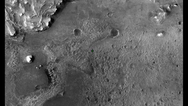This image shows with a green dot where NASA's Perseverance rover landed in Jezero Crater on Mars on Feb. 18, 2021. The base image was taken by the HiRISE camera aboard NASA's Mars Reconnaissance Orbiter. A key objective for Perseverance's mission on Mars is astrobiology, including the search for signs of ancient microbial life. The rover will characterize the planet's geology and past climate, pave the way for human exploration of the Red Planet, and be the first mission to collect and cache Martian rock and regolith (broken rock and dust). Subsequent NASA missions, in cooperation with ESA (European Space Agency), would send spacecraft to Mars to collect these sealed samples from the surface and return them to Earth for in-depth analysis. The Mars 2020 Perseverance mission is part of NASA's Moon to Mars exploration approach, which includes Artemis missions to the Moon that will help prepare for human exploration of the Red Planet. https://photojournal.jpl.nasa.gov/catalog/PIA24331