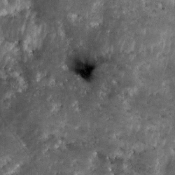 The High Resolution Imaging Experiment (HiRISE) camera aboard NASA's Mars Reconnaissance Orbiter (MRO) was able to capture this image of the final location of the heat shield that helped protect NASA's Perseverance rover during its landing on the surface of Mars. The image was taken on Feb. 19, 2021.  It is a close-up version of a larger image showing several parts of the Mars 2020 mission landing system that got the rover safely on the ground.  These close-ups of Mars 2020 hardware were processed to make them easier to see.  A key objective for Perseverance's mission on Mars is astrobiology, including the search for signs of ancient microbial life. The rover will characterize the planet's geology and past climate, pave the way for human exploration of the Red Planet, and be the first mission to collect and cache Martian rock and regolith (broken rock and dust).  Subsequent NASA missions, in cooperation with ESA (European Space Agency), would send spacecraft to Mars to collect these sealed samples from the surface and return them to Earth for in-depth analysis.  The Mars 2020 Perseverance mission is part of NASA's Moon to Mars exploration approach, which includes Artemis missions to the Moon that will help prepare for human exploration of the Red Planet.  https://photojournal.jpl.nasa.gov/catalog/PIA24337