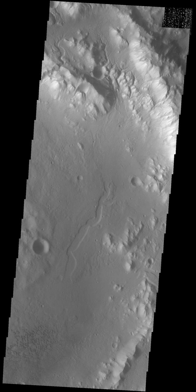 Today's VIS image shows part of an unnamed crater in southern Terra Cimmeria. The rim of the crater is dissected by several channels (top of image) and the floor contains a small group of sand dunes (bottom of image). Orbit Number: 84031 Latitude: -33.338 Longitude: 163.552 Instrument: VIS Captured: 2020-11-23 09:26 https://photojournal.jpl.nasa.gov/catalog/PIA24366