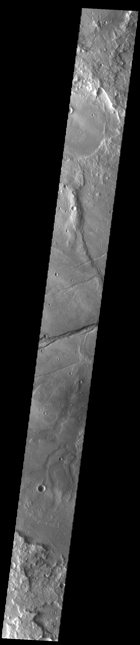 The linear depression in this VIS image is part of Sirenum Fossae. Depressions of this type are called graben, which form by the down drop of material between two parallel faults. The faults are caused by tectonic stresses in the region. The Sirenum Fossae graben are 2735km (1700 miles) long.  Orbit Number: 84379 Latitude: -32.7135 Longitude: 204.562 Instrument: VIS Captured: 2020-12-22 01:06  https://photojournal.jpl.nasa.gov/catalog/PIA24398