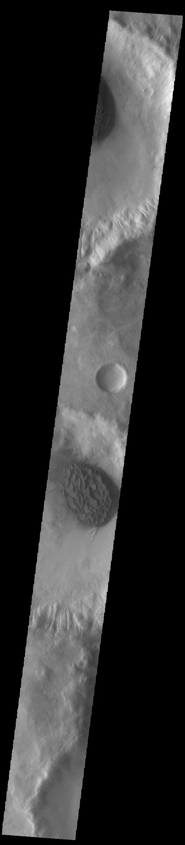This VIS image shows sand sheets in two unnamed craters located in Noachis Terra. Both sand sheets have dune forms on the surface of the sand sheet. These craters are close to Matara Crater, which also contains a large sand sheet with surface dune forms.  Orbit Number: 84572 Latitude: -48.5416 Longitude: 34.0463 Instrument: VIS Captured: 2021-01-06 22:34  https://photojournal.jpl.nasa.gov/catalog/PIA24414