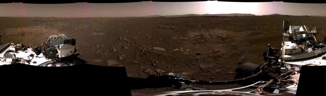 This panorama, taken on Feb. 20, 2021, by the Navigation Cameras, or Navcams, aboard NASA's Perseverance Mars rover, was stitched together from six individual images after they were sent back to Earth.  A key objective for Perseverance's mission on Mars is astrobiology, including the search for signs of ancient microbial life. The rover will characterize the planet's geology and past climate, pave the way for human exploration of the Red Planet, and be the first mission to collect and cache Martian rock and regolith.  Subsequent missions, currently under consideration by NASA in cooperation with ESA (European Space Agency), would send spacecraft to Mars to collect these cached samples from the surface and return them to Earth for in-depth analysis.  The Mars 2020 Perseverance mission is part of NASA's Moon to Mars exploration approach, which includes Artemis missions to the Moon that will help prepare for human exploration of the Red Planet.  https://photojournal.jpl.nasa.gov/catalog/PIA24422