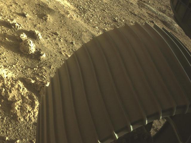 This high-resolution image shows one of the six wheels aboard NASA's Perseverance Mars rover, which landed on Feb. 18, 2021. The image was taken by one of Perseverance's color Hazard Cameras (Hazcams). A key objective for Perseverance's mission on Mars is astrobiology, including the search for signs of ancient microbial life. The rover will characterize the planet's geology and past climate, pave the way for human exploration of the Red Planet, and be the first mission to collect and cache Martian rock and regolith (broken rock and dust). Subsequent NASA missions, in cooperation with ESA (the European Space Agency), would send spacecraft to Mars to collect these cached samples from the surface and return them to Earth for in-depth analysis. https://photojournal.jpl.nasa.gov/catalog/PIA24429
