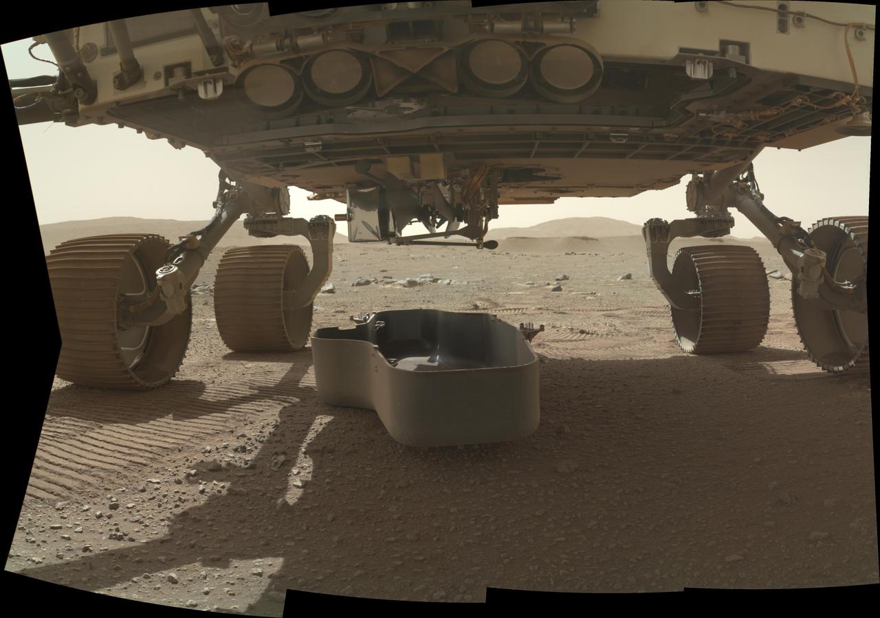 The debris shield, a protective covering on the bottom of NASA's Perseverance rover, was released on March 21, 2021, the 30th Martian day, or sol, of the mission. The debris shield protects the agency's Ingenuity helicopter during landing; releasing it allows the helicopter to rotate down out of the rover's belly. This image was taken by the WATSON (Wide Angle Topographic Sensor for Operations and eNgineering) camera on the SHERLOC (Scanning Habitable Environments with Raman and Luminescence for Organics and Chemicals) instrument, located at the end of the rover's long robotic arm. NASA's Jet Propulsion Laboratory built and manages operations of Perseverance and Ingenuity for the agency. Caltech in Pasadena, California, manages JPL for NASA. WATSON was built by Malin Space Science Systems in San Diego, and is operated jointly by MSSS and JPL. The Mars helicopter technology demonstration activity is supported by NASA's Science Mission Directorate, the NASA Aeronautics Research Mission Directorate, and the NASA Space Technology Mission Directorate. A key objective for Perseverance's mission on Mars is astrobiology, including the search for signs of ancient microbial life. The rover will characterize the planet's geology and past climate, pave the way for human exploration of the Red Planet, and be the first mission to collect and cache Martian rock and regolith (broken rock and dust). Subsequent NASA missions, in cooperation with ESA (European Space Agency), would send spacecraft to Mars to collect these sealed samples from the surface and return them to Earth for in-depth analysis. The Mars 2020 Perseverance mission is part of NASA's Moon to Mars exploration approach, which includes Artemis missions to the Moon that will help prepare for human exploration of the Red Planet. Animation available at https://photojournal.jpl.nasa.gov/catalog/PIA24448
