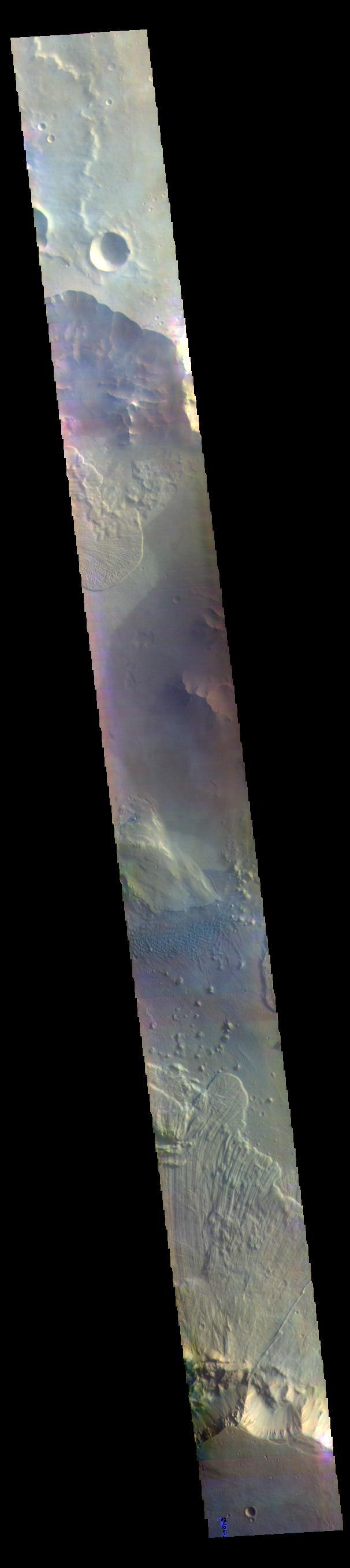 The THEMIS VIS camera contains 5 filters. The data from different filters can be combined in multiple ways to create a false color image. These false color images may reveal subtle variations of the surface not easily identified in a single band image. Today's false color image shows part of Ganges Chasma. A large landslide deposit fills the bottom third of the image, and another landslide deposit is visible near the top of the image. The radial grooves on the top of a landslide are a common feature formed by the downslope movement of the landslide materials. A field of dunes is visible in the center of the image. Ganges Chasma is part of the Valles Marineris chasma system, but is north of the main section of canyons. Ganges Chasma is 584km (363 miles) long.  Orbit Number: 70657 Latitude: -7.47135 Longitude: 315.505 Instrument: VIS Captured: 2017-11-18 00:19  https://photojournal.jpl.nasa.gov/catalog/PIA24504