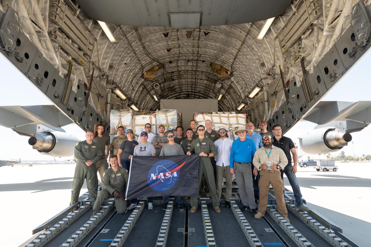 Some of the people who helped to load the hardware for the Surface Water and Ocean Topography (SWOT) satellite's research instruments onto a C-17 airplane pose for a picture. The payload left March Air Reserve Base in Riverside County, California, on June 27, 2021, and is headed to France. Once the SWOT research hardware arrives at a clean room facility near Cannes, France, engineers and technicians will complete assembly of the satellite over the next year.  SWOT will make global surveys of Earth's surface water. By measuring its height, researchers can track the volume and location of the finite resource around the world. The data will help with monitoring changes in floodplains and wetlands, measure how much fresh water flows into and out of lakes and rivers and back to the ocean, and track regional shifts in sea level.  https://photojournal.jpl.nasa.gov/catalog/PIA24535