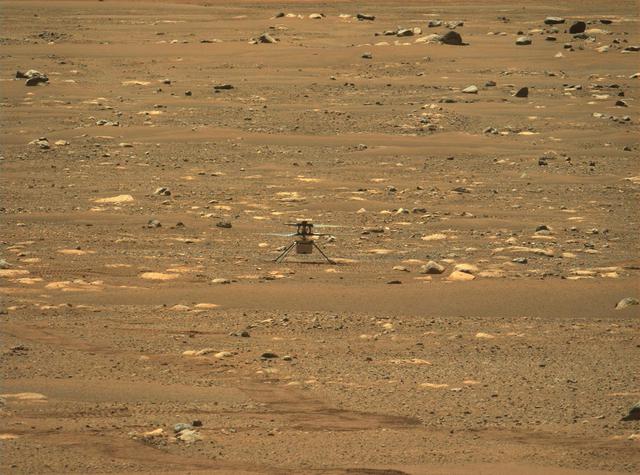 This image was taken after the first flight of NASA's Ingenuity Mars Helicopter — and the first powered, controlled flight on another planet. It was captured by Mastcam-Z, a pair of zoomable cameras aboard NASA's Perseverance Mars rover, on April 19, 2021.  Flying in a controlled manner on Mars is far more difficult than flying on Earth. The Red Planet has significant gravity (about one-third that of Earth's), but its atmosphere is just 1% as dense as Earth's at the surface.  Stitched together from multiple images, the mosaic is not white balanced; instead, it is displayed in a preliminary calibrated version of a natural color composite, approximately simulating the colors of the scene that we would see if we were there viewing it ourselves.  Arizona State University in Tempe leads the operations of the Mastcam-Z instrument, working in collaboration with Malin Space Science Systems in San Diego.  A key objective for Perseverance's mission on Mars is astrobiology, including the search for signs of ancient microbial life. The rover will characterize the planet's geology and past climate, pave the way for human exploration of the Red Planet, and be the first mission to collect and cache Martian rock and regolith (broken rock and dust).  Subsequent NASA missions, in cooperation with ESA (European Space Agency), would send spacecraft to Mars to collect these sealed samples from the surface and return them to Earth for in-depth analysis.  The Mars 2020 Perseverance mission is part of NASA's Moon to Mars exploration approach, which includes Artemis missions to the Moon that will help prepare for human exploration of the Red Planet.  https://photojournal.jpl.nasa.gov/catalog/PIA24550