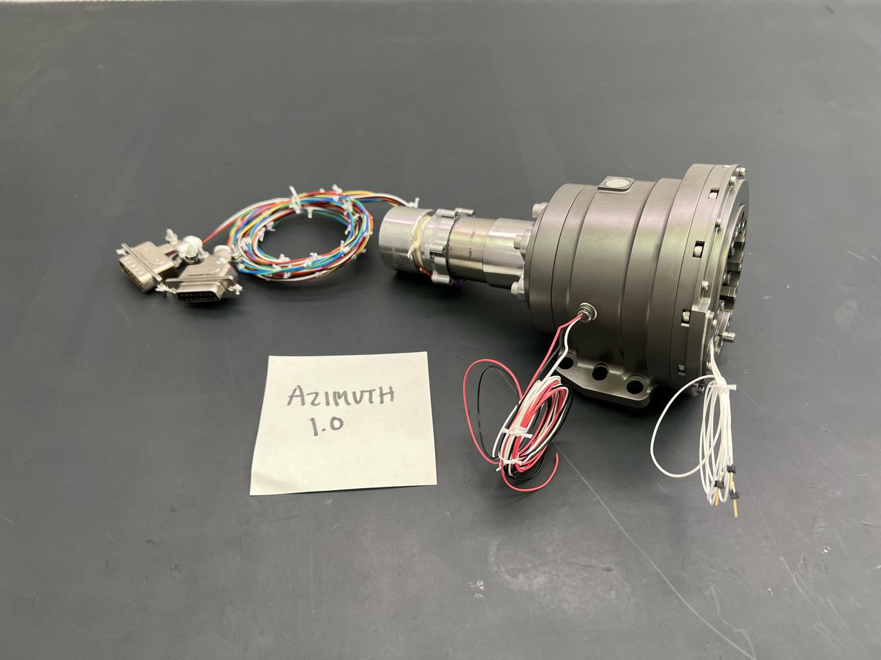 In early 2022, the Cold Operable Lunar Deployable Arm (COLDArm) project – led by NASA's Jet Propulsion Laboratory in Southern California – successfully integrated special gears into pieces of a robotic arm that is planned to perform a robot-controlled lunar surface experiment with imagery in the coming years.  These bulk metallic glass (BMG) gears, integrated into COLDArm's joints and actuators, were developed through the Game Changing Development bulk metallic glass gears project to operate at extreme temperatures below minus 280 degrees Fahrenheit (minus 173 degrees Celsius). The gear alloys have a disordered atomic-scale structure, making them both strong and elastic enough to withstand these exceptionally low temperatures. Typical gearboxes require heating to operate at such cryogenic temperatures. The BMG gear motors have been tested and successfully operated at roughly minus 279 degrees Fahrenheit (minus 173 degrees Celsius) without heating assistance. This gear motor is one of the key technologies to enable the robotic arm to operate in extremely cold environments, such as during lunar night.  Each of the four joints containing BMG gears will be tested once the arm is fully assembled, which is scheduled for spring of 2022. Robotic joint testing will include dynamometer testing to measure torque/rotational speed, as well as cryogenic thermal vacuum testing to understand how the equipment would perform in an environment similar to space. Once proven, the BMG gears and COLDArm capabilities will enable future missions to work in extreme environments on the Moon, Mars, and ocean worlds.  https://photojournal.jpl.nasa.gov/catalog/PIA24567