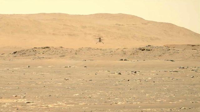 NASA's Ingenuity Mars Helicopter hovers and rotates over Jezero Crater during its second experimental flight test on April 22, 2021. The footage was captured by the Mastcam-Z imager, a pair of zoomable cameras aboard NASA's Perseverance Mars rover.  Altimeter data from the solar-powered helicopter indicates it climbed to its prescribed maximum altitude of 16 feet (5 meters), flew downrange 7 feet (2 meters) and returned, performed several turns while in a hover, and landed. Total flight time 51.9 seconds.  Flying in a controlled manner on Mars is far more difficult than flying on Earth. The Red Planet has significant gravity (about one-third that of Earth's), but an atmosphere with only about 1% of the density at Earth's surface.  Stitched together from multiple images, the mosaic is not white balanced; instead, it is displayed in a preliminary calibrated version of a natural-color composite, approximately simulating the colors of the scene as it would appear on Mars.  Arizona State University in Tempe leads the operations of the Mastcam-Z instrument, working in collaboration with Malin Space Science Systems in San Diego.  The Ingenuity Mars Helicopter was built by JPL, which also manages this technology demonstration project for NASA Headquarters. It is supported by NASA's Science Mission Directorate, Aeronautics Research Mission Directorate, and Space Technology Mission Directorate. NASA's Ames Research Center and Langley Research Center provided significant flight performance analysis and technical assistance during Ingenuity's development.  A key objective for Perseverance's mission on Mars is astrobiology, including the search for signs of ancient microbial life. The rover will characterize the planet's geology and past climate, pave the way for human exploration of the Red Planet, and be the first mission to collect and cache Martian rock and regolith (broken rock and dust).  Subsequent NASA missions, in cooperation with ESA (European Space Agency), would send spacecraft to Mars to collect these sealed samples from the surface and return them to Earth for in-depth analysis.  The Mars 2020 Perseverance mission is part of NASA's Moon to Mars exploration approach, which includes Artemis missions to the Moon that will help prepare for human exploration of the Red Planet.  Movie available at https://photojournal.jpl.nasa.gov/catalog/PIA24595