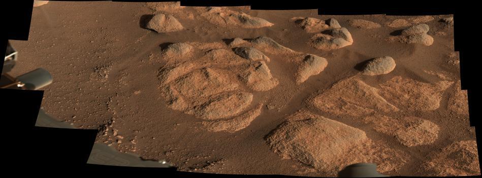 NASA's Perseverance Mars rover viewed these rocks using its Mastcam-Z imager on April 27, 2021, the 66th Martian day, or sol, of the mission. Stitched together from 21 images, this mosaic is not white balanced; instead, it is displayed in a preliminary calibrated version of a natural-color composite, approximately simulating the colors of the scene as it would appear on Mars.  For scale, the largest piece of rock casting a shadow in the upper right part of the mosaic is about 11 inches (27 centimeters) across, and the entire scene is about 10 feet (3 meters) across. The smallest pebbles and other features that can reliably be resolved at this zoom scale are around 0.04 to 0.08 inches (1-2 millimeters) across.  The scene was also captured in enhanced color (Figure 1) as well as a color anaglyph made for viewing through red-blue 3D glasses (Figure 2).  Arizona State University in Tempe leads the operations of the Mastcam-Z instrument, working in collaboration with Malin Space Science Systems in San Diego.  A key objective for Perseverance's mission on Mars is astrobiology, including the search for signs of ancient microbial life. The rover will characterize the planet's geology and past climate, pave the way for human exploration of the Red Planet, and be the first mission to collect and cache Martian rock and regolith (broken rock and dust).  Subsequent NASA missions, in cooperation with ESA (European Space Agency), would send spacecraft to Mars to collect these sealed samples from the surface and return them to Earth for in-depth analysis.  The Mars 2020 Perseverance mission is part of NASA's Moon to Mars exploration approach, which includes Artemis missions to the Moon that will help prepare for human exploration of the Red Planet.  https://photojournal.jpl.nasa.gov/catalog/PIA24627