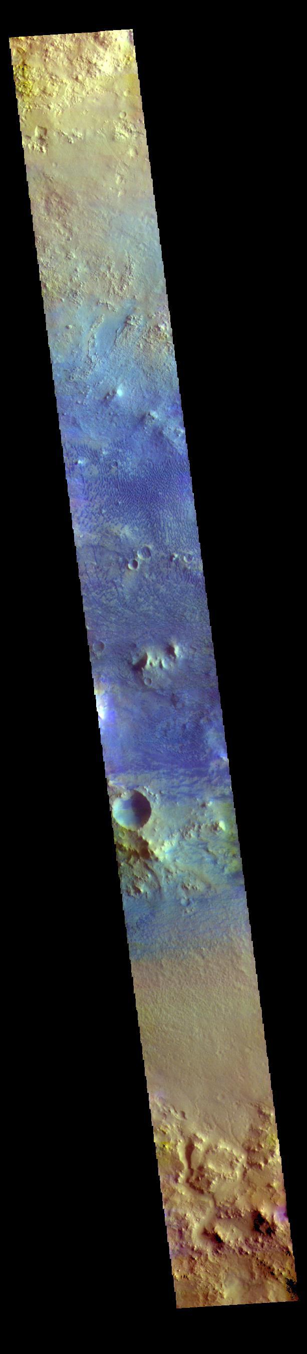 The THEMIS VIS camera contains 5 filters. The data from different filters can be combined in multiple ways to create a false color image. These false color images may reveal subtle variations of the surface not easily identified in a single band image. Today's false color image shows a cross section of Baldet Crater. Dark blue tones in this filter combination indicate basaltic sands. A large field of dunes is visible on the floor of the crater. Baldet Crater is located in Terra Sabaea and is 181km (112 miles) in diameter.  Orbit Number: 77776 Latitude: 22.6741 Longitude: 65.6646 Instrument: VIS Captured: 2019-06-27 09:22  https://photojournal.jpl.nasa.gov/catalog/PIA24635