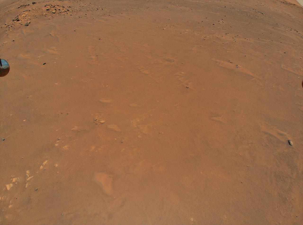 NASA's Ingenuity Mars Helicopter took this color image from an altitude of 33 feet (10 meters) during its fifth flight on May 7, 2021. This was the helicopter's first one-way flight, and it settled down at a new landing location 423 feet (129 meters) south of its previous location at Wright Brothers Field. The contrast has been enhanced to show surface details.  https://photojournal.jpl.nasa.gov/catalog/PIA24650