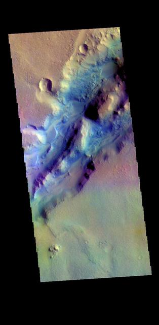 The THEMIS VIS camera contains 5 filters. The data from different filters can be combined in multiple ways to create a false color image. These false color images may reveal subtle variations of the surface not easily identified in a single band image. The linear depressions in today's false color image are part of Nili Fossae. Nili Fossae is a collection of curved faults and down-dropped blocks of crust between the faults called graben. The "fossae," or graben, lie northeast of the large volcano Syrtis Major and northwest of the ancient impact basin Isidis Planitia. The graben, which can be almost 500 meters (1,600 feet) deep, make concentric curves that follow the outline of Isidis Planitia. The graben likely formed as the crust sagged under the weight of lava flows filling the Isidis Planitia impact basin.  Orbit Number: 79198 Latitude: 23.3867 Longitude: 78.7424 Instrument: VIS Captured: 2019-10-22 11:40  https://photojournal.jpl.nasa.gov/catalog/PIA24658