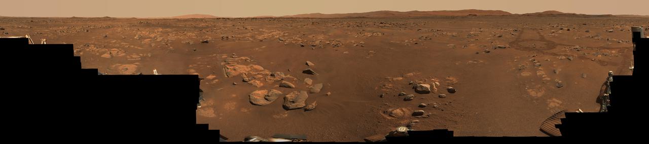 NASA's Perseverance Mars rover used its Mastcam-Z stereo imaging system to capture this 360-degree panorama of "Van Zyl Overlook," where the rover was parked for 13 days as the Ingenuity helicopter performed its first flights. The 2.4 billion-pixel panorama is made up of 992 individual right-eye Mastcam-Z images stitched together. The images were taken between April 15 and 26, 2021, or the 53rd and 64th Martian days, or sols, of the mission.  A few small patches of near-field sand had been covered by parts of Perseverance when the right-eye Mastcam-Z images were taken; those gaps were filled with images of the same sandy patches taken by the Mastcam-Z left-eye camera at the same time, or from the earlier navigation camera images. Imaging coverage of the sky has also been digitally smoothed and expanded based on the actual sky color observed as the panorama was being acquired on Mars.  Arizona State University in Tempe leads the operations of the Mastcam-Z instrument, working in collaboration with Malin Space Science Systems in San Diego.  A key objective for Perseverance's mission on Mars is astrobiology, including the search for signs of ancient microbial life. The rover will characterize the planet's geology and past climate, pave the way for human exploration of the Red Planet, and be the first mission to collect and cache Martian rock and regolith (broken rock and dust).  Subsequent NASA missions, in cooperation with ESA (European Space Agency), would send spacecraft to Mars to collect these sealed samples from the surface and return them to Earth for in-depth analysis.  The Mars 2020 Perseverance mission is part of NASA's Moon to Mars exploration approach, which includes Artemis missions to the Moon that will help prepare for human exploration of the Red Planet.  https://photojournal.jpl.nasa.gov/catalog/PIA24663