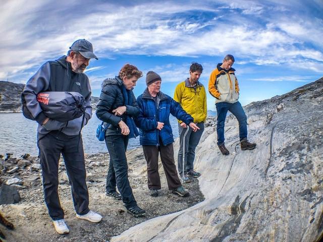 Abigail Allwood (second from left), principal investigator of the Planetary Instrument for X-ray Lithochemistry (PIXL) aboard NASA's Perseverance Mars rover, is seen here examining rocks at a site in Greenland. Allwood is a scientist based at NASA's Jet Propulsion Laboratory in Southern California.  A key objective for Perseverance's mission on Mars is astrobiology, including the search for signs of ancient microbial life. The rover will characterize the planet's geology and past climate, pave the way for human exploration of the Red Planet, and be the first mission to collect and cache Martian rock and regolith (broken rock and dust).  Subsequent NASA missions, in cooperation with ESA (European Space Agency), would send spacecraft to Mars to collect these sealed samples from the surface and return them to Earth for in-depth analysis.  The Mars 2020 Perseverance mission is part of NASA's Moon to Mars exploration approach, which includes Artemis missions to the Moon that will help prepare for human exploration of the Red Planet.  https://photojournal.jpl.nasa.gov/catalog/PIA24668