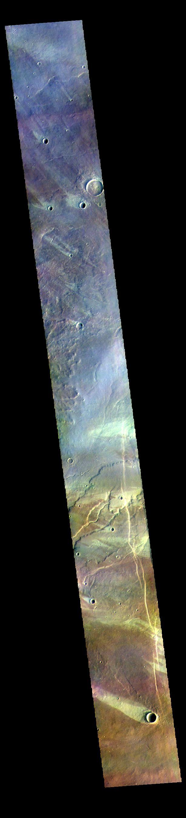 The THEMIS VIS camera contains 5 filters. The data from different filters can be combined in multiple ways to create a false color image. These false color images may reveal subtle variations of the surface not easily identified in a single band image. Today's false color image shows multiple windstreaks on the plains west of Alba Mons. The color variation shows where wind action has removed or concentrated surface dust. The "tails" of the windstreaks indicate wind direction, in this case from the lower right of the image towards the upper left.  Orbit Number: 81738 Latitude: 38.9673 Longitude: 239.118 Instrument: VIS Captured: 2020-05-18 15:10  https://photojournal.jpl.nasa.gov/catalog/PIA24704