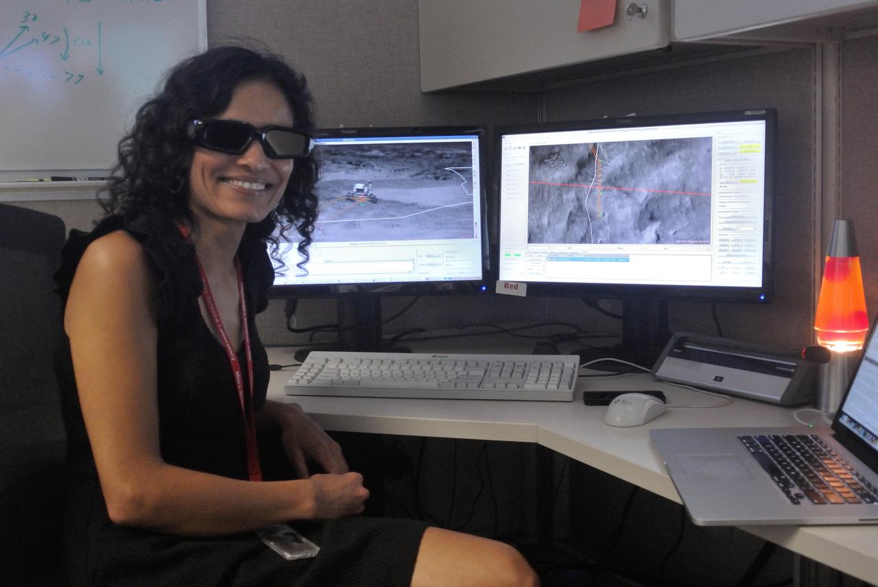 Vandi Verma, an engineer who now works with NASA's Perseverance Mars rover, is seen here working as a driver for the Curiosity rover. The special 3D glasses she's wearing are still used by rover drivers to easily detect changes in terrain that the rover may need to avoid. A key objective for Perseverance's mission on Mars is astrobiology, including the search for signs of ancient microbial life. The rover will characterize the planet's geology and past climate, pave the way for human exploration of the Red Planet, and be the first mission to collect and cache Martian rock and regolith (broken rock and dust). Subsequent NASA missions, in cooperation with ESA (European Space Agency), would send spacecraft to Mars to collect these sealed samples from the surface and return them to Earth for in-depth analysis. The Mars 2020 Perseverance mission is part of NASA's Moon to Mars exploration approach, which includes Artemis missions to the Moon that will help prepare for human exploration of the Red Planet. https://photojournal.jpl.nasa.gov/catalog/PIA24724
