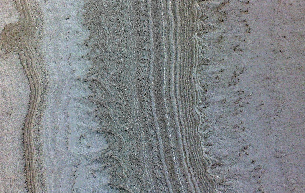 This image taken by NASA's Mars Reconnaissance Orbiter (MRO) shows ice sheets at Mars' south pole. The spacecraft detected clays near this ice; scientists have proposed such clays are the source of radar reflections that have been previously interpreted as liquid water using data from the ESA (European Space Agency) Mars Express orbiter. Flying 186 miles (300 kilometers) above the Martian surface, MRO used its High-Resolution Imaging Science Experiment (HiRISE) camera to study the ice sheets while using its Compact Reconnaissance Imaging Spectrometer (CRISM) to map out clay minerals near the ice. https://photojournal.jpl.nasa.gov/catalog/PIA24763