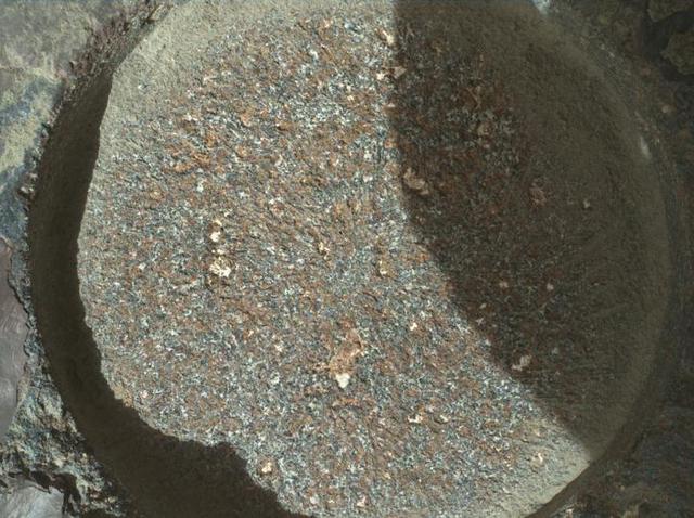 NASA's Perseverance Mars rover used its WATSON (Wide Angle Topographic Sensor for Operations and eNgineering) camera to take eight images – combined here into the single composite image – of a rock abraded by a tool on the rover's robotic arm. The images were taken on Aug. 27, 2021 (the 185th Martian day, or sol, of the mission). Nicknamed "Bellegarde," the abraded target is 0.4 inches (5 centimeters) in diameter.  A subsystem of SHERLOC, WATSON can document the structure and texture within a drilled or abraded target, and its data can be used to derive depth measurements. The area within the blue box is roughly 6.5 millimeters squared.  NASA's Jet Propulsion Laboratory built and manages operations of Perseverance and Ingenuity for the agency. Caltech in Pasadena, California, manages JPL for NASA. WATSON was built by Malin Space Science Systems (MSSS) in San Diego and is operated jointly by MSSS and JPL.  A key objective for Perseverance's mission on Mars is astrobiology, including the search for signs of ancient microbial life. The rover will characterize the planet's geology and past climate, pave the way for human exploration of the Red Planet, and be the first mission to collect and cache Martian rock and regolith (broken rock and dust).  Subsequent NASA missions, in cooperation with ESA (European Space Agency), would send spacecraft to Mars to collect these sealed samples from the surface and return them to Earth for in-depth analysis.  The Mars 2020 Perseverance mission is part of NASA's Moon to Mars exploration approach, which includes Artemis missions to the Moon that will help prepare for human exploration of the Red Planet.  https://photojournal.jpl.nasa.gov/catalog/PIA24770