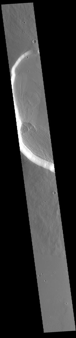 Today's VIS image shows the western side of the summit caldera on the volcano called Uranius Mons. Uranius Mons is 4.8 kilometers (3 miles) high with shallow slopes. The surrounding volcanic plains are younger than the volcano itself and originated at other volcanic centers in the Tharsis region. Orbit Number: 85356 Latitude: 25.5498 Longitude: 266.521 Instrument: VIS Captured: 2021-03-12 12:40 https://photojournal.jpl.nasa.gov/catalog/PIA24777