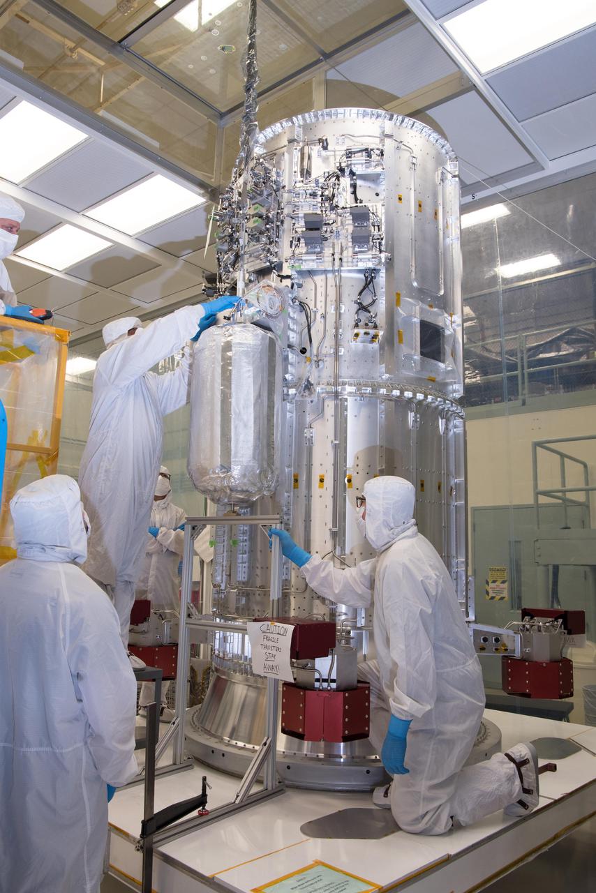 Engineers and technicians in a clean room at NASA's Goddard Space Flight Center in Greenbelt, Maryland, integrate the tanks that will contain helium onto the propulsion module of NASA's Europa Clipper spacecraft. The 10-foot-tall (3-meter-tall) propulsion module was also integrated with 16 rocket engines at Goddard. The module then was shipped to the Johns Hopkins Applied Physics Laboratory (APL) in Laurel, Maryland, where engineers will install electronics, radios, antennas, and cabling. In 2022, this major piece of hardware will ship to NASA's Jet Propulsion Laboratory in Southern California for assembly, test, and launch operations.  With an internal global ocean under a thick layer of ice, Jupiter's moon Europa may have the potential to harbor existing life. The Europa Clipper spacecraft will swoop around Jupiter on an elliptical path, dipping close to the moon on each flyby to collect data. Understanding Europa's habitability will help scientists better understand how life developed on Earth and the potential for finding life beyond our planet. Europa Clipper is set to launch in 2024.  https://photojournal.jpl.nasa.gov/catalog/PIA24782