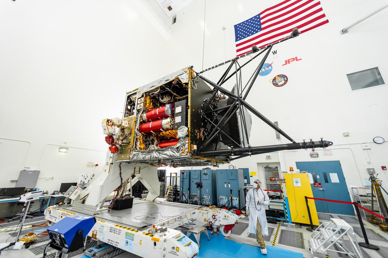 NASA's Psyche spacecraft is captured here on August 18, 2021, in a clean room at the agency's Jet Propulsion Laboratory in Southern California – in the midst of system integration and test. The mission's launch period opens August 1, 2022.  The nitrogen tanks are visible in the center of the spacecraft chassis, encased in red protective "remove before flight" covers. Mounted on the right is the strut tower, which will host the sensors for two of the science instruments – the magnetometer and the Gamma Ray and Neutron Spectrometer (GRNS).  By spring of 2022, the fully assembled Psyche spacecraft will ship from JPL to NASA's Kennedy Space Center for launch. In early 2026, the spacecraft will arrive at its target, an asteroid of the same name in the main asteroid belt between Mars and Jupiter. Scientists believe asteroid Psyche, which is about 140 miles (226 kilometers) wide, is made largely of iron and nickel and could be the core of an early planet. The spacecraft will spend 21 months orbiting the asteroid and gathering science data. Besides the magnetometer and the GRNS, Psyche will carry a multispectral imager.  The mission also will test a sophisticated new laser communications technology, recently completed by JPL, called Deep Space Optical Communications (DSOC). The technology demonstration will focus on using lasers to enhance communications speeds and prepare for data-intensive transmissions, which could potentially include livestream videos for future missions.  Arizona State University leads the mission. JPL is responsible for the mission's overall management, system engineering, integration and testing, and mission operations. Maxar Technologies is providing a high-power solar electric propulsion spacecraft chassis. Psyche is the 14th mission selected as part of NASA's Discovery Program.  https://photojournal.jpl.nasa.gov/catalog/PIA24787