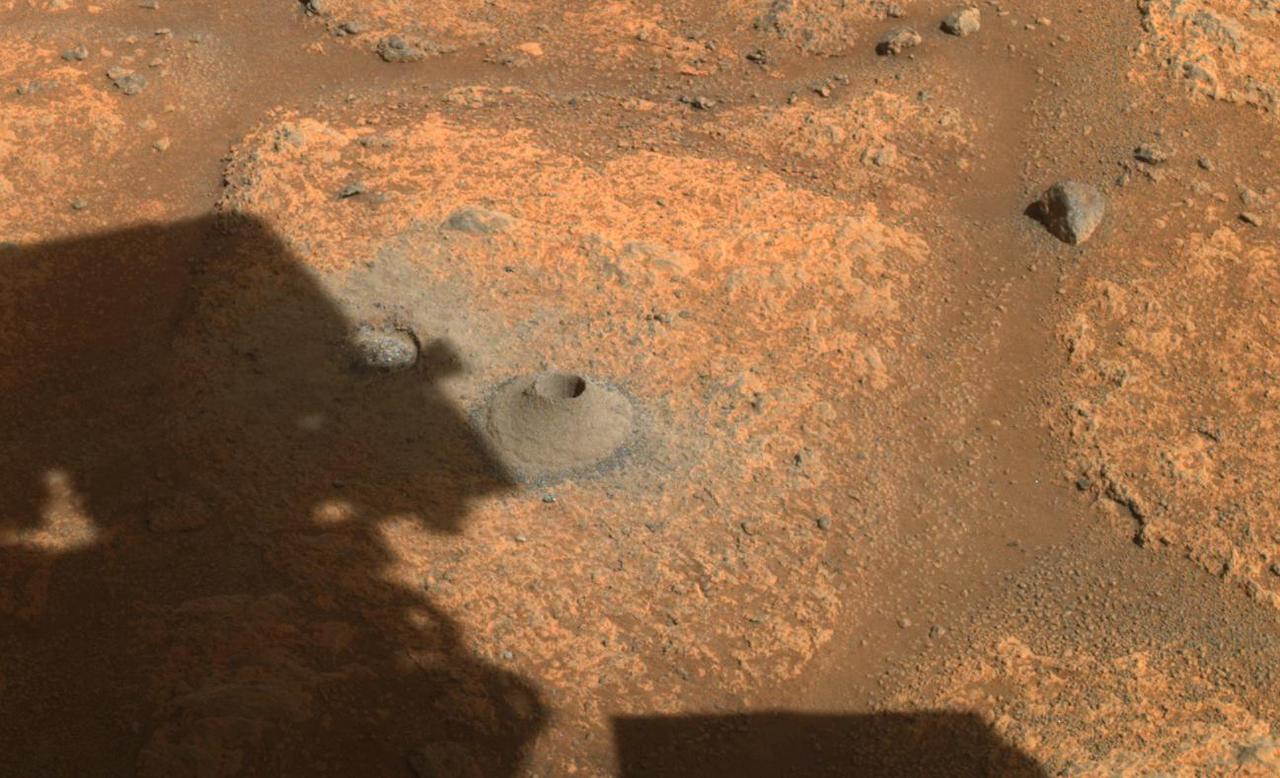 This image taken by NASA's Perseverance rover on August 6, 2021, shows the hole drilled in a Martian rock in preparation for the rover's first attempt to collect a sample. It was taken by one of the rover's hazard cameras in what the rover's science team has nicknamed a "paver rock" in the "Crater Floor Fractured Rough" area of Jezero Crater. A key objective for Perseverance's mission on Mars is astrobiology, including the search for signs of ancient microbial life. The rover will characterize the planet's geology and past climate, pave the way for human exploration of the Red Planet, and be the first mission to collect and cache Martian rock and regolith (broken rock and dust). Subsequent NASA missions, in cooperation with ESA (European Space Agency), would send spacecraft to Mars to collect these sealed samples from the surface and return them to Earth for in-depth analysis. The Mars 2020 Perseverance mission is part of NASA's Moon to Mars exploration approach, which includes Artemis missions to the Moon that will help prepare for human exploration of the Red Planet. https://photojournal.jpl.nasa.gov/catalog/PIA24795