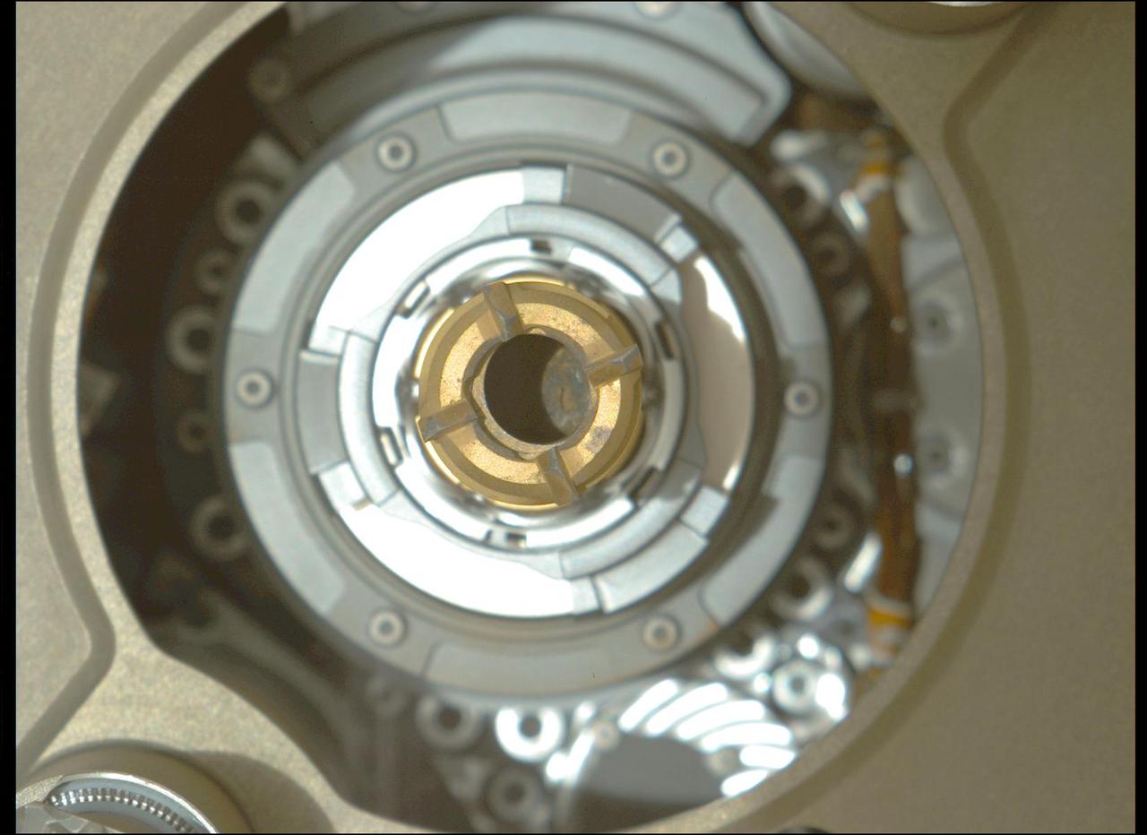 This image taken by the Mastcam-Z camera aboard NASA's Perseverance rover on Sept. 4, 2021, confirmed that the rover had retained a rock core in the sample tube held in the drill at the end of its robotic arm. After Perseverance drilled the hole called "Montdenier" in the rock nicknamed "Rochette" on Sept. 1 and acquired the rock core, which is slightly thicker than a pencil, the rover vibrated it to clear any material stuck between the coring bit and the sample tube within the bit. The rover then conducted additional imaging to double-check that it retained the rock. This image has been processed to enhance contrast. A key objective for Perseverance's mission on Mars is astrobiology, including the search for signs of ancient microbial life. The rover will characterize the planet's geology and past climate, pave the way for human exploration of the Red Planet, and be the first mission to collect and cache Martian rock and regolith. The Mars 2020 Perseverance mission is part of NASA's Moon to Mars exploration approach, which includes Artemis missions to the Moon that will help prepare for human exploration of the Red Planet. Subsequent NASA missions, in cooperation with ESA (European Space Agency), would send spacecraft to Mars to collect these sealed samples from the surface and return them to Earth for in-depth analysis. https://photojournal.jpl.nasa.gov/catalog/PIA24832