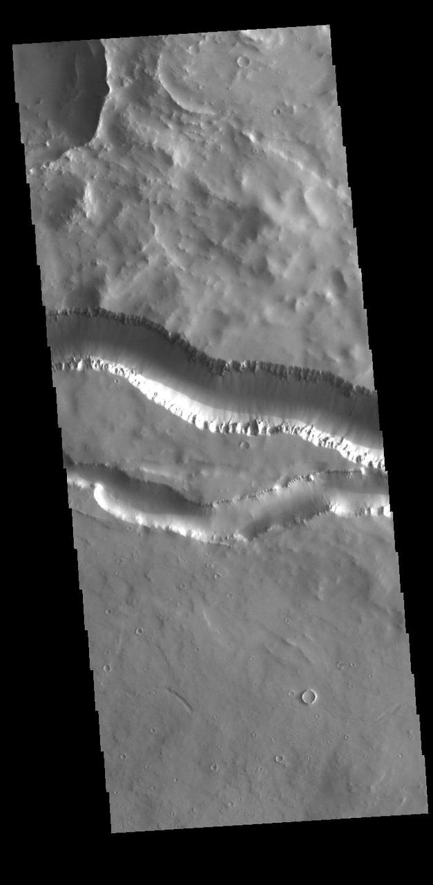 This VIS image shows two segments of the channel system called Granicus Valles. Granicus Valles is a complex channel system located west of Elysium Mons. The system is approximately 750km (466 miles) long. It is likely that both water and lava played a part in creation of this feature. Orbit Number: 85635 Latitude: 24.8871 Longitude: 137.814 Instrument: VIS Captured: 2021-04-04 12:00 https://photojournal.jpl.nasa.gov/catalog/PIA24859